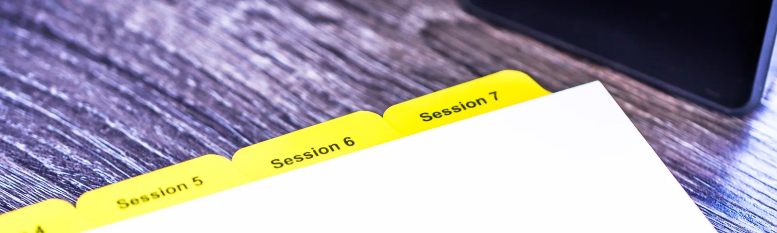 Custom yellow Mylar index tabs printed Session 5, Session 6 and Session 7 — die-cut, printed and Mylar-reinforced by Anselmo Die & Index, Schaumburg IL, family-owned since 1978